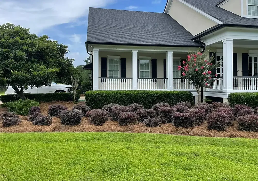 Front porch entry with mulch landscape bed and curved edging along foundation